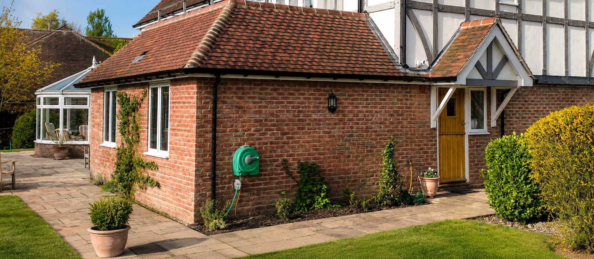 Finished brick extension opening onto a landscaped garden