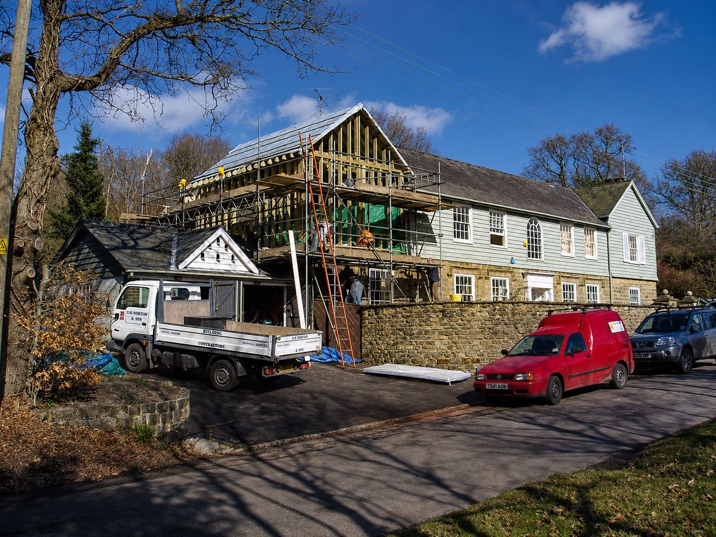 Timber-framed extension under construction with scaffolding
